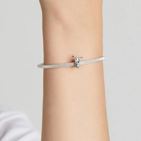 Motorcycle Charm for Pandora Bracelets - Harley-Davidson bike Delight - A sleek sterling silver bracelet with a detailed Harley-Davidson motorcycle charm, elegantly wrapped around a wrist, showcasing a blend of biker spirit and refined style.