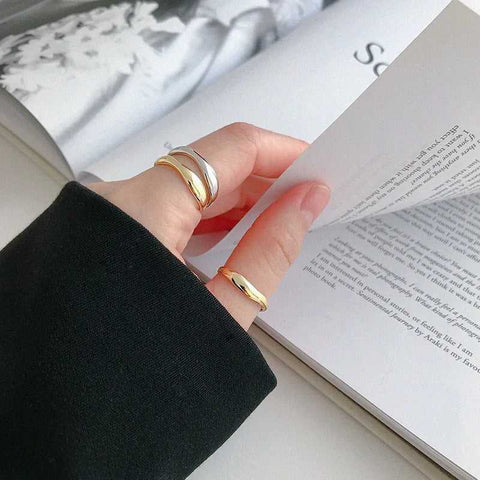 Minimalist Gold Wave Open Ring - Hand wearing gold and silver minimalist adjustable rings, showcasing their sleek design.