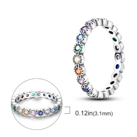 Sterling Silver Rainbow Gemstone Eternity Band - CZ Ring - An elegant silver ring adorned with multicolored gemstones, shown close up with a focus on its detailed design