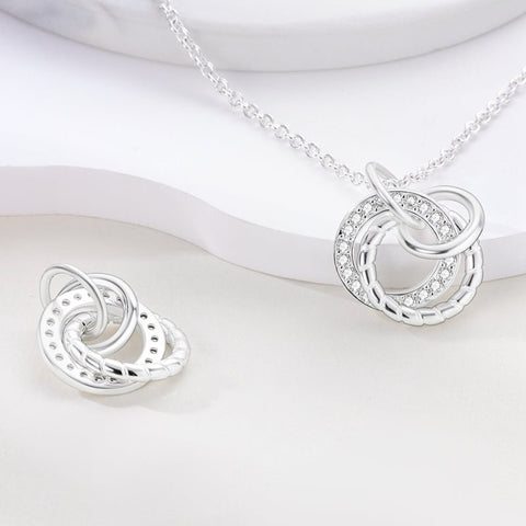 Classic Silver Circle Pendant Necklace with Crystals - Elegant sterling silver necklace with interlocking circular pendants, featuring cubic zirconia accents, displayed on a white background.