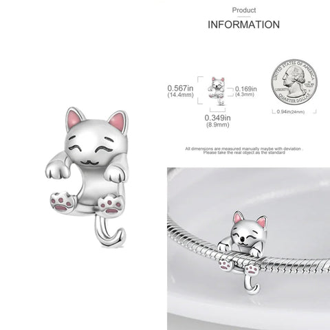 Hanging Silver Cat Charm - charm of a cat playfully hanging from a bracelet, featuband pink paws and a cute expression.