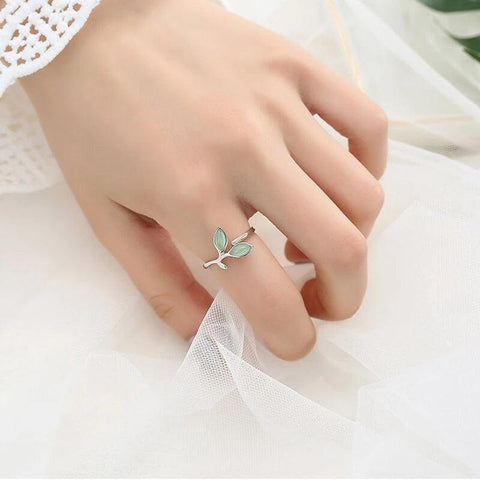 Adjustable Silver Ring Green Leaf-Shaped Gemstones - Adjustable Silver Ring with Green Leaf-Shaped Gemstones - a woman's hand wearing a ring with a green stone