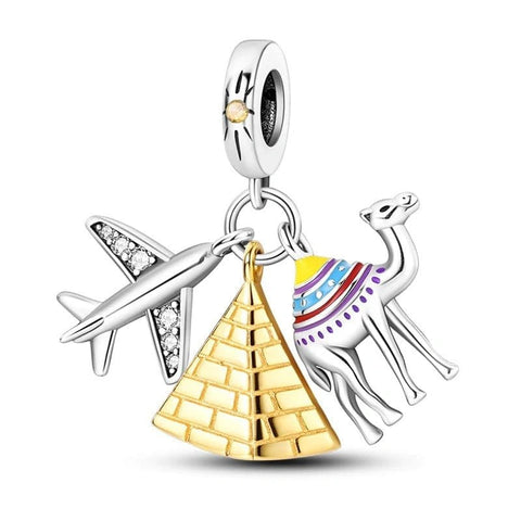 Jewelry charm with airplane, pyramid, and camel on a white background