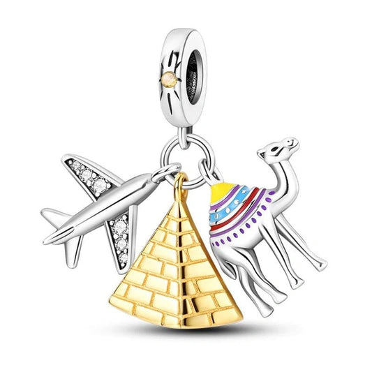 Jewelry charm with airplane, pyramid, and camel on a white background