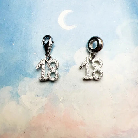 Two silver number eighteen charms.