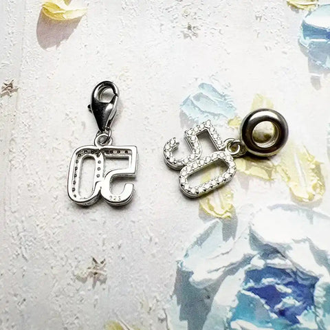 Two silver number charms.