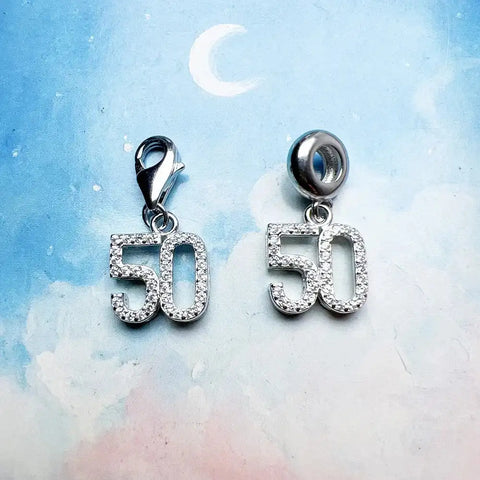 Two silver ''' charms.