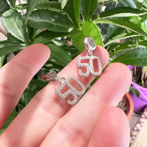 Two silver ''' pendants.