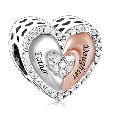 Heart-shaped charm with 'Father' and 'Angel' engraved on a white background