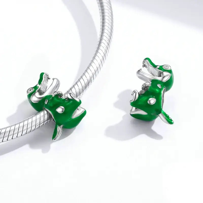 Sterling silver and green enamel dinosaur charm designed to fit Pandora bracelets.