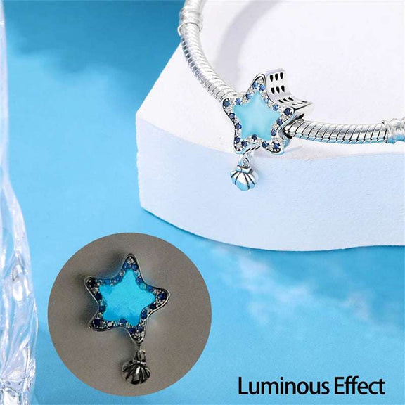 Blue Star Charm with Shell - Blue star-shaped charm with crystal border and a small silver shell pendant.