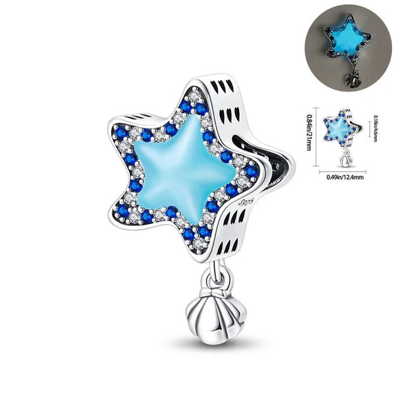 Blue Star Charm with Shell - Sterling silver star charm with blue enamel center and crystal accents.