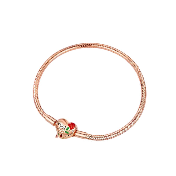 Rose Gold Enchanted Heart Clasp Charm Bracelet - Rose gold snake chain bracelet with an intricate heart clasp, worn on a woman's wrist.