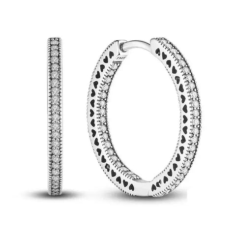 Sterling Silver Hoop Earrings Heart Cutouts - Sterling silver hoop earrings with heart cutouts.