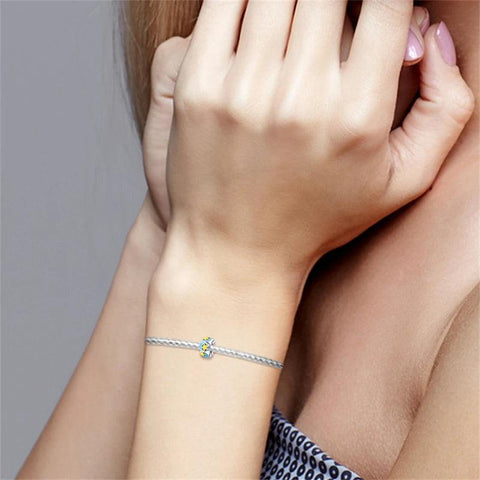 Celestial Stars and Moon Charm - Sterling silver charm with blue enamel, featuring yellow stars and crescent moons.