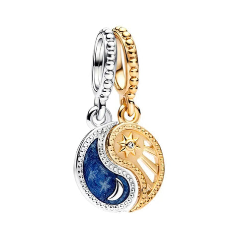 Yin Yang Sun and Moon Charm with Crystals - Gold and silver pendant with blue and white design on a white background