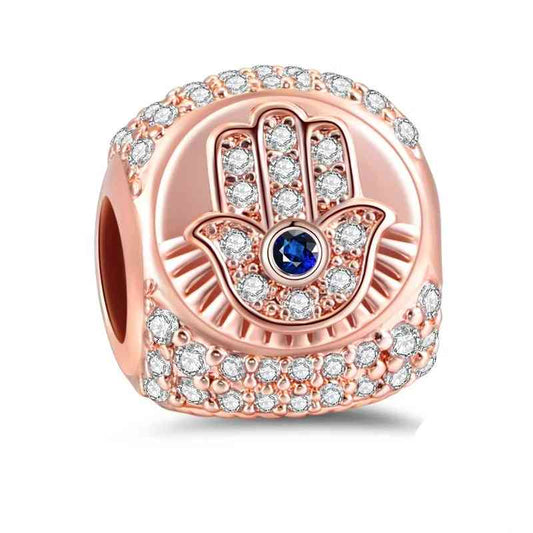 Rose gold Hand of Fatima charm with sapphire, symbolizing protection on Pandora charm bracelets.