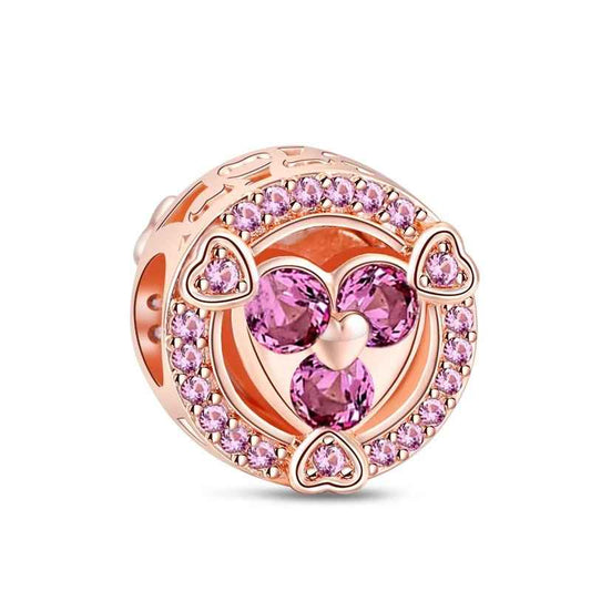 Rose gold heart charm with pink gemstones and crystals, adding sparkle to Pandora charm bracelets.