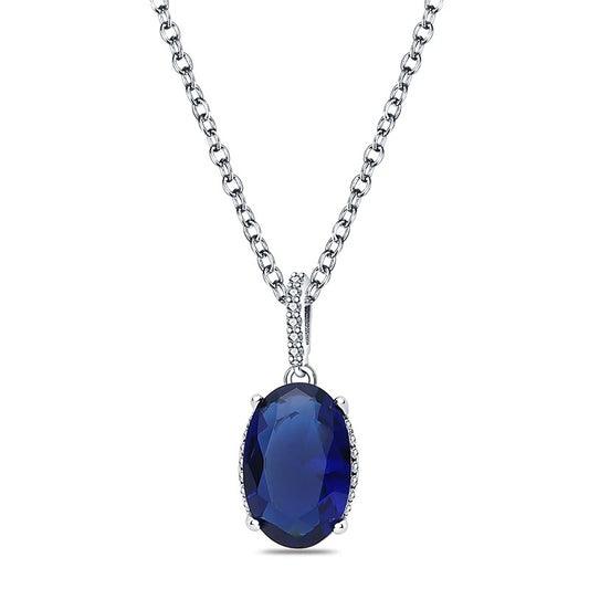 A sterling silver necklace featuband an elegant oval blue sapphire pendant with cubic zirconia.
