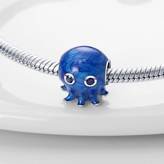 Deep Blue Octopus Charm with Crystal Eyes in Sterling Silver - Sterling silver blue octopus charm with sparkling blue gemstone eyes.