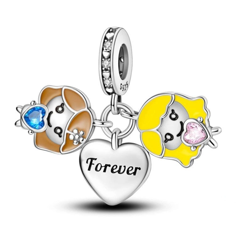 Sterling silver charm featuband two girls with heart-shaped gemstones.