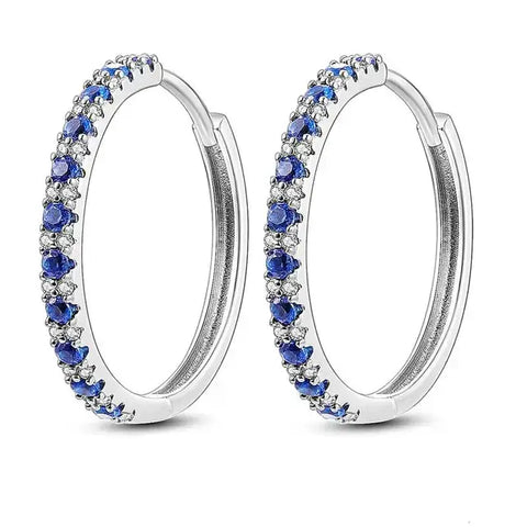 Sterling Silver Blue CZ Hoop Earrings - Sterling silver hoop earrings with alternating blue and clear cubic zirconia stones.