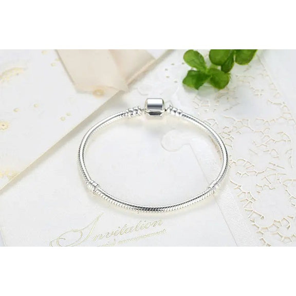 Geometric Hexagon Sterling Silver Charm Bracelet - Elegant silver bracelet displayed on a white invitation card, showcasing its smooth, flexible band and modern square charm.