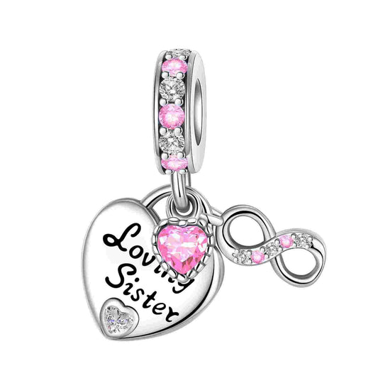 Sterling silver charm featuring "Loving Sister" inscription and pink and white crystals.