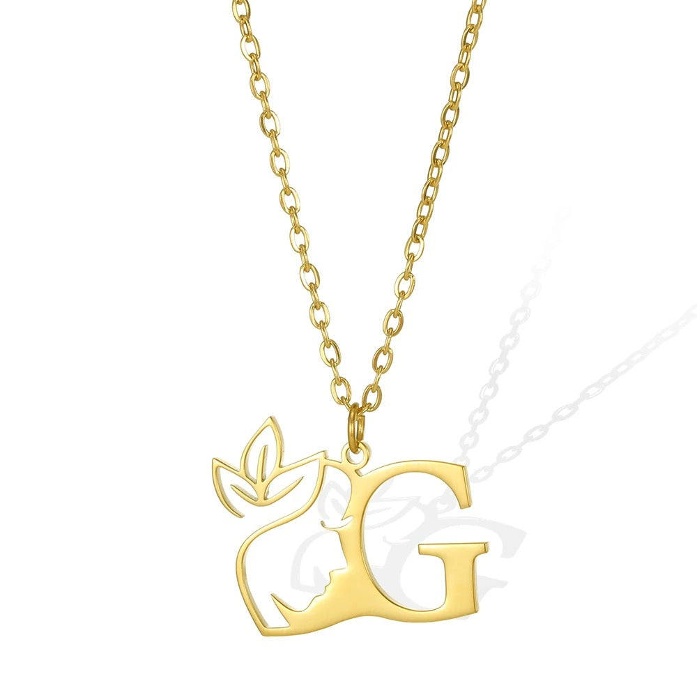 G: Gorgeous gold necklace featuring a 'G' pendant and an ornate leaflet.