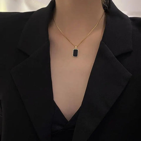 Elegant gold-plated necklace with a black stone square pendant, perfect for sophisticated looks.