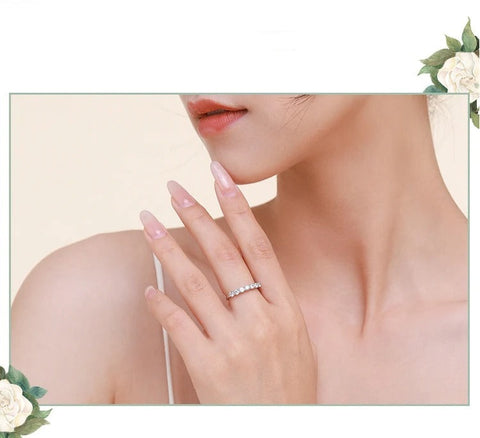 A model wearing the silver ring on her finger, highlighting its elegant and