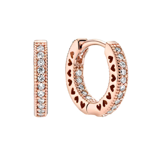 Rose gold hoop earrings with heart detailing and sparkling stones, featuring a luxurious design.