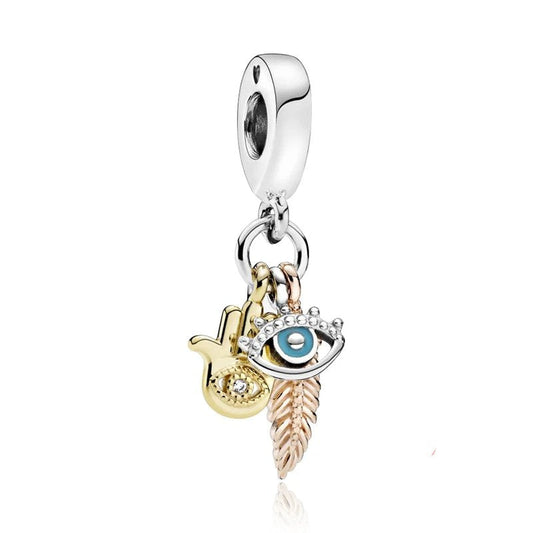 Sterling silver charm with evil eye, hamsa hand, and feather with gold and rose gold accents.