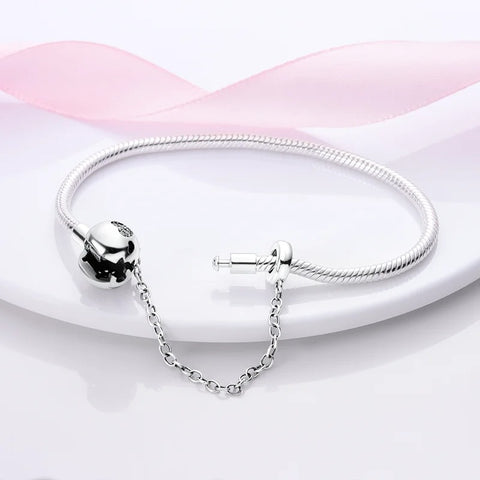 Protective Heart Sterling Silver Snake Chain Charm Bracelet - Protective heart charm sterling silver snake chain bracelet with heart cutout.