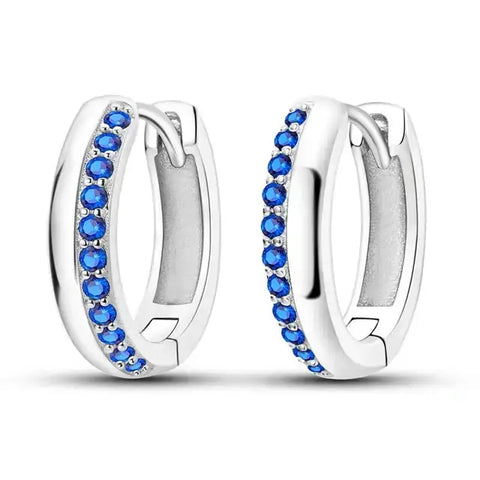 Sterling Silver Blue CZ Huggie Earrings - Sterling silver huggie earrings with blue cubic zirconia stones.