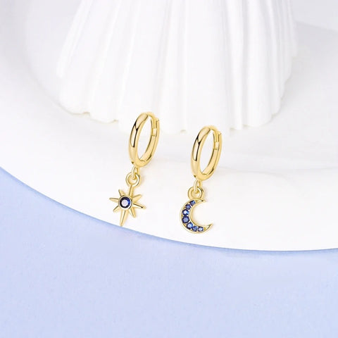 Silver Gold Rose Gold Star Moon Drop Earrings - Gold hoop earrings with star and moon charms displayed on a white surface.