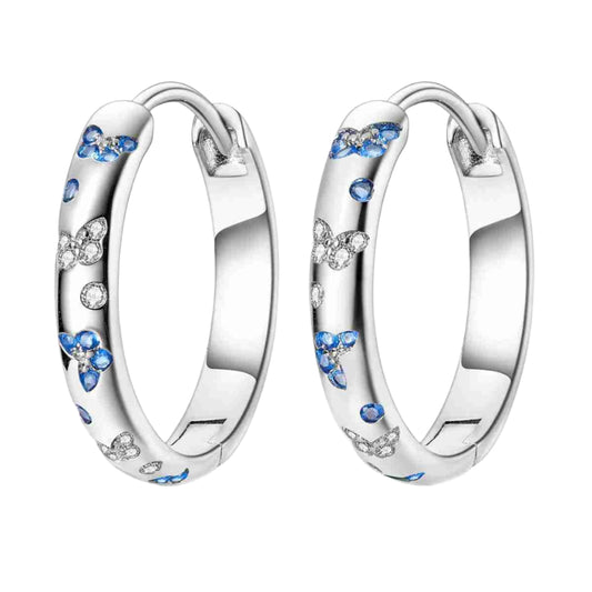 Sterling silver hoop earrings with blue and white floral designs.