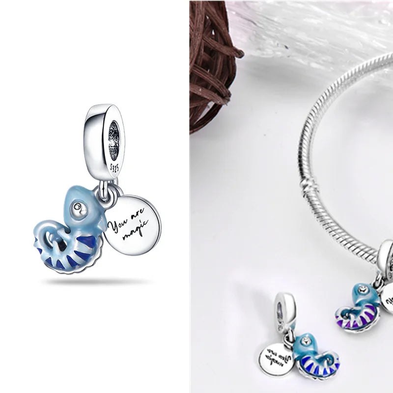 Enamel blue seashell charm with "You are magic" engraved silver tag.