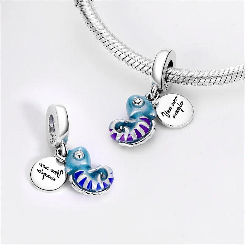 Blue seashell and silver charm with motivational inscription "You are magic".