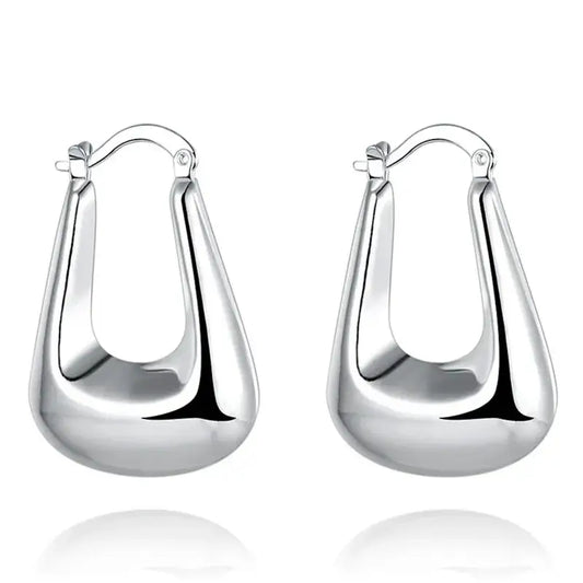 Modern silver teardrop hoop earrings on a white background.