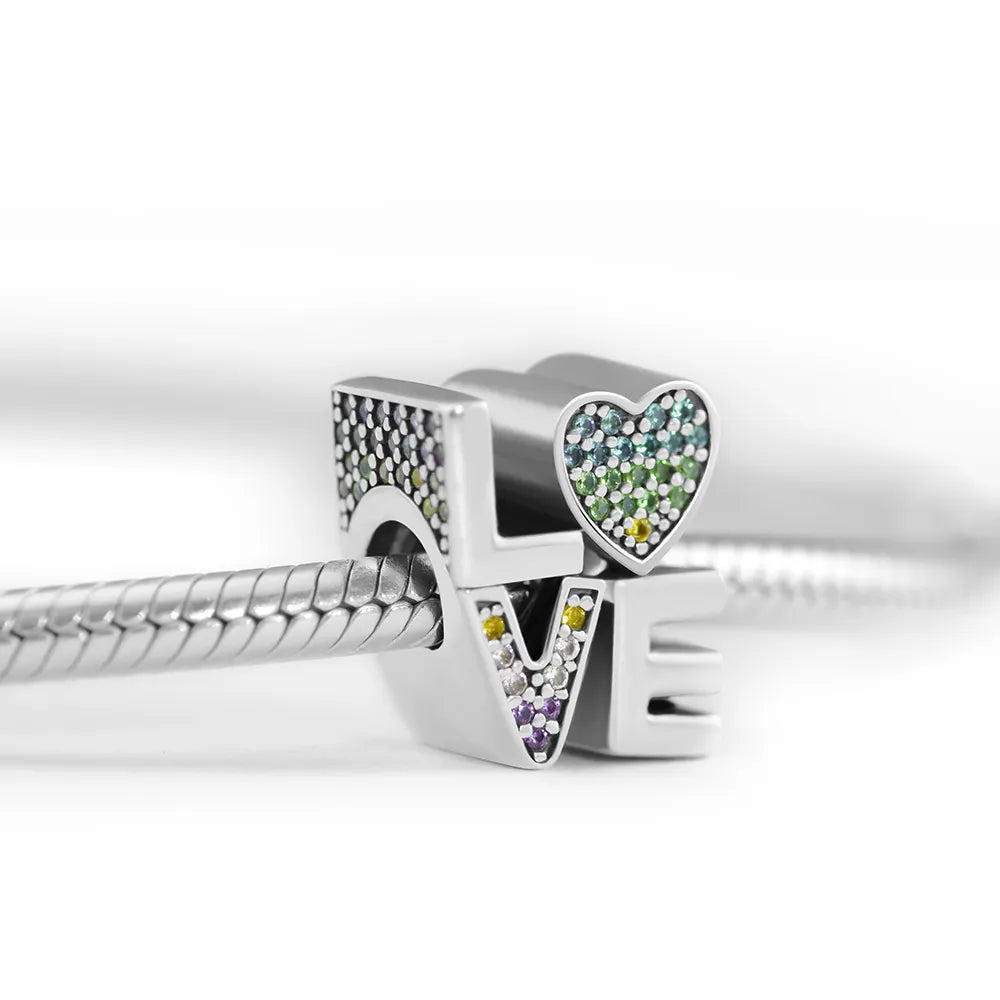 LOVE charm in sterling silver featuring multicolored crystals and a bracelet attachment hole.