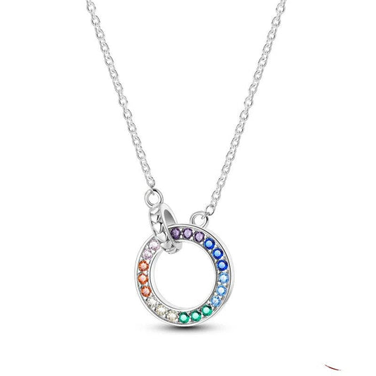 Sterling silver necklace with a circle pendant adorned with multicolored stones.