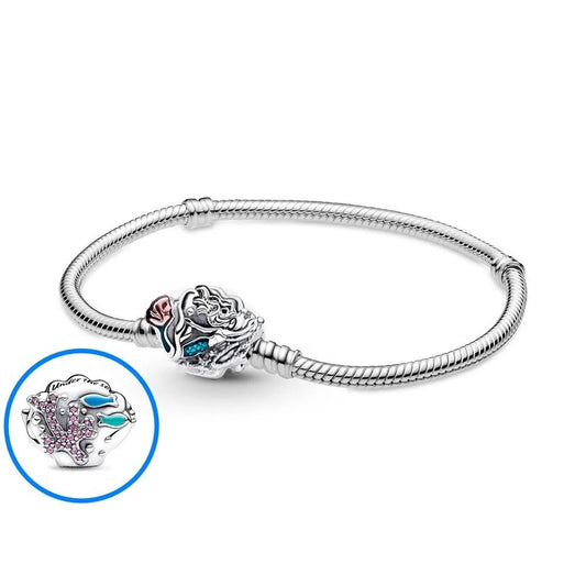 Sterling silver bracelet with an intricate seashell clasp, adorned with pink and blue gemstones.