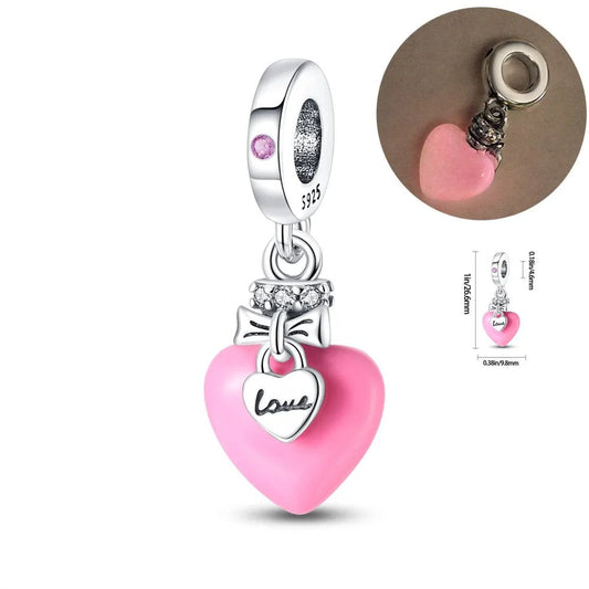 Pink heart charm with a smaller silver heart inscribed with "Love," made from 925 sterling silver.