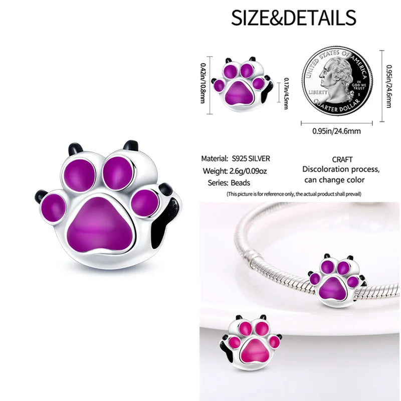 Sterling silver charm with purple paw print design and color-changing enamel.