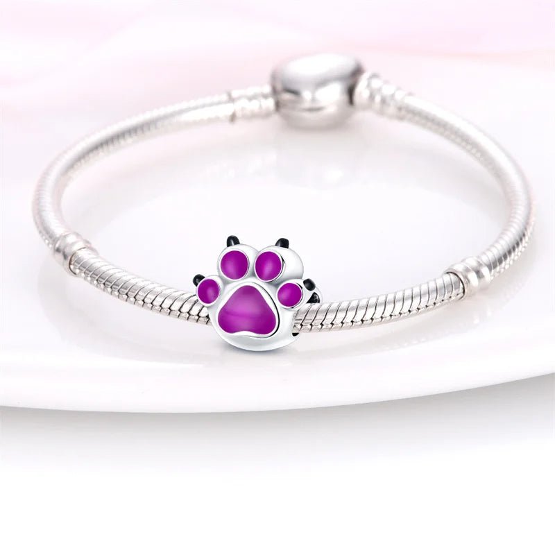 Purple paw print charm with color-changing enamel in sterling silver.