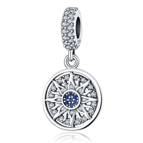 Radiant Sunburst Charm with Blue and Clear Crystals in Sterling Silver - Sterling silver sunburst charm with blue and clear crystals, featuband an intricate design.