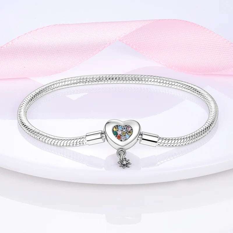 Sterling silver snake chain bracelet with a rainbow-colored heart charm and a small dangling star, fits Pandora charms.