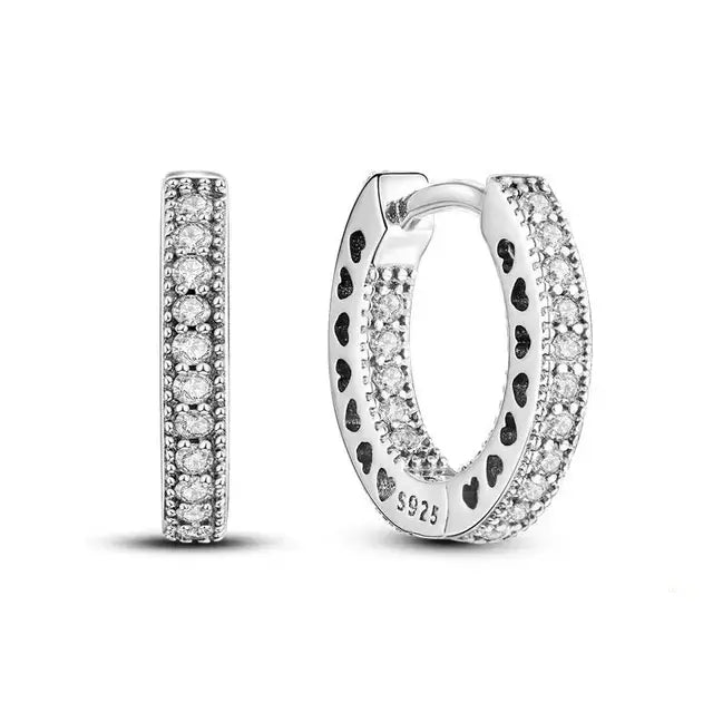 Sterling silver pave set huggie earrings with cubic zirconia stones.