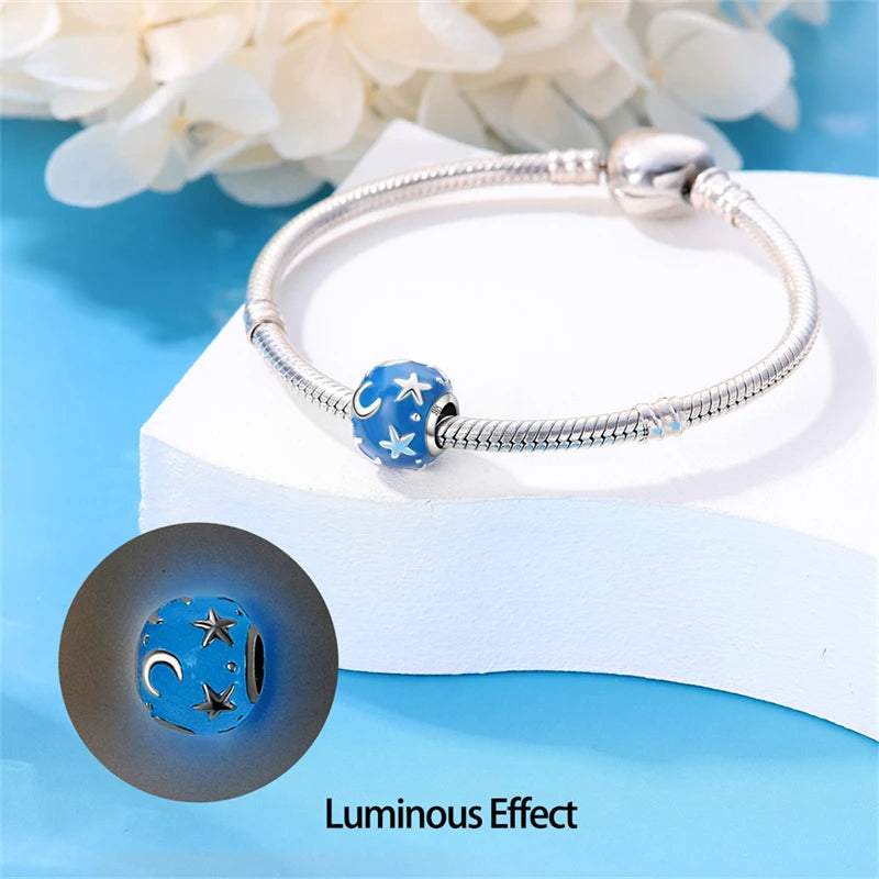 925 sterling silver charm featuring a blue enamel surface with star and moon details.